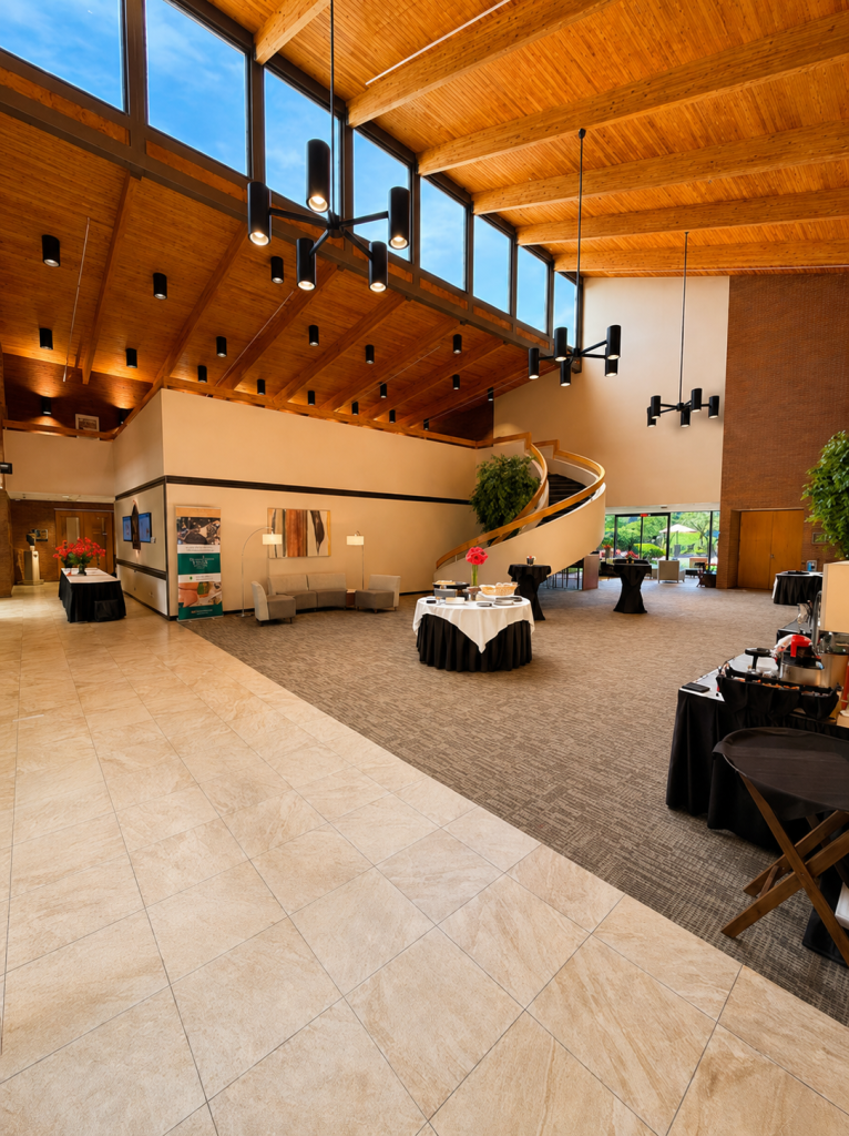 The lobby interior featuring large vaulted ceiling and hanging lights .