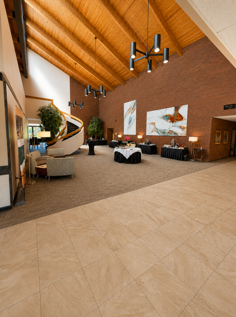 A view of the lobby featuring the high ceilings and wall art against a brick wall.