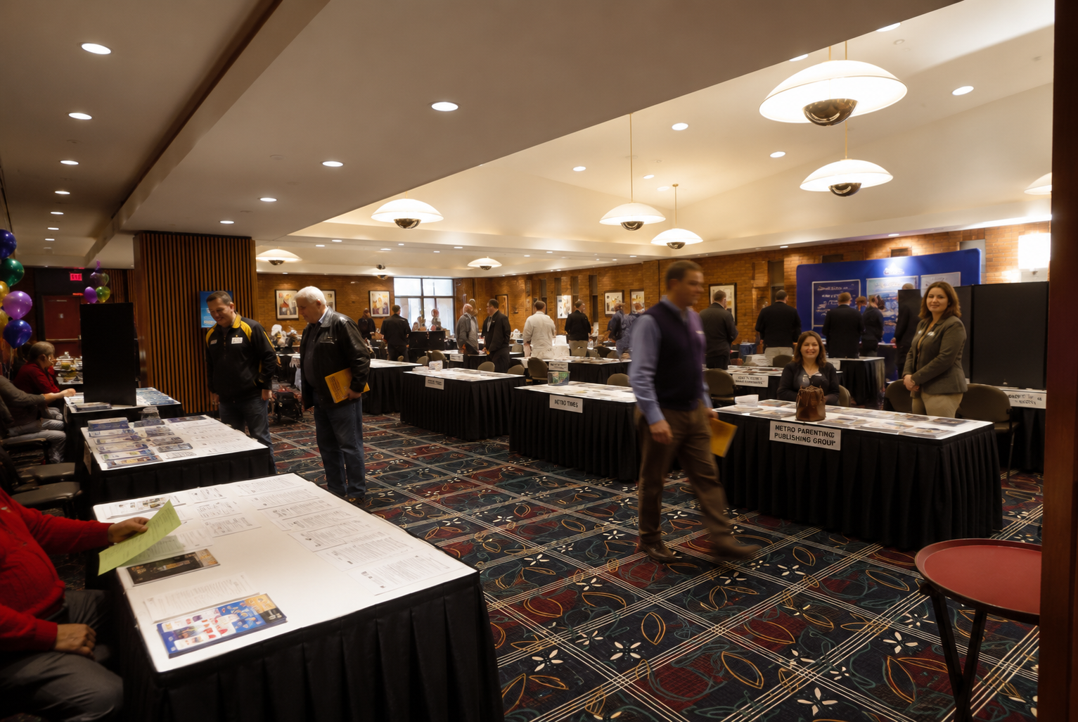 an example of a trade show in the dining room space at MEC with rows of company tables displaying their various products.